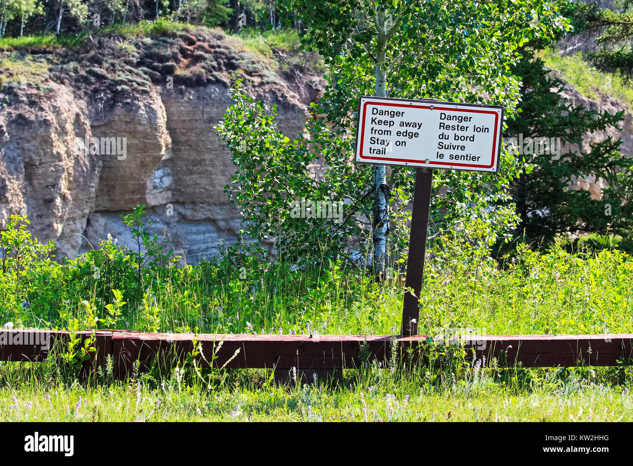 Danger keep away from edge stay on trail sign. Stock Photo