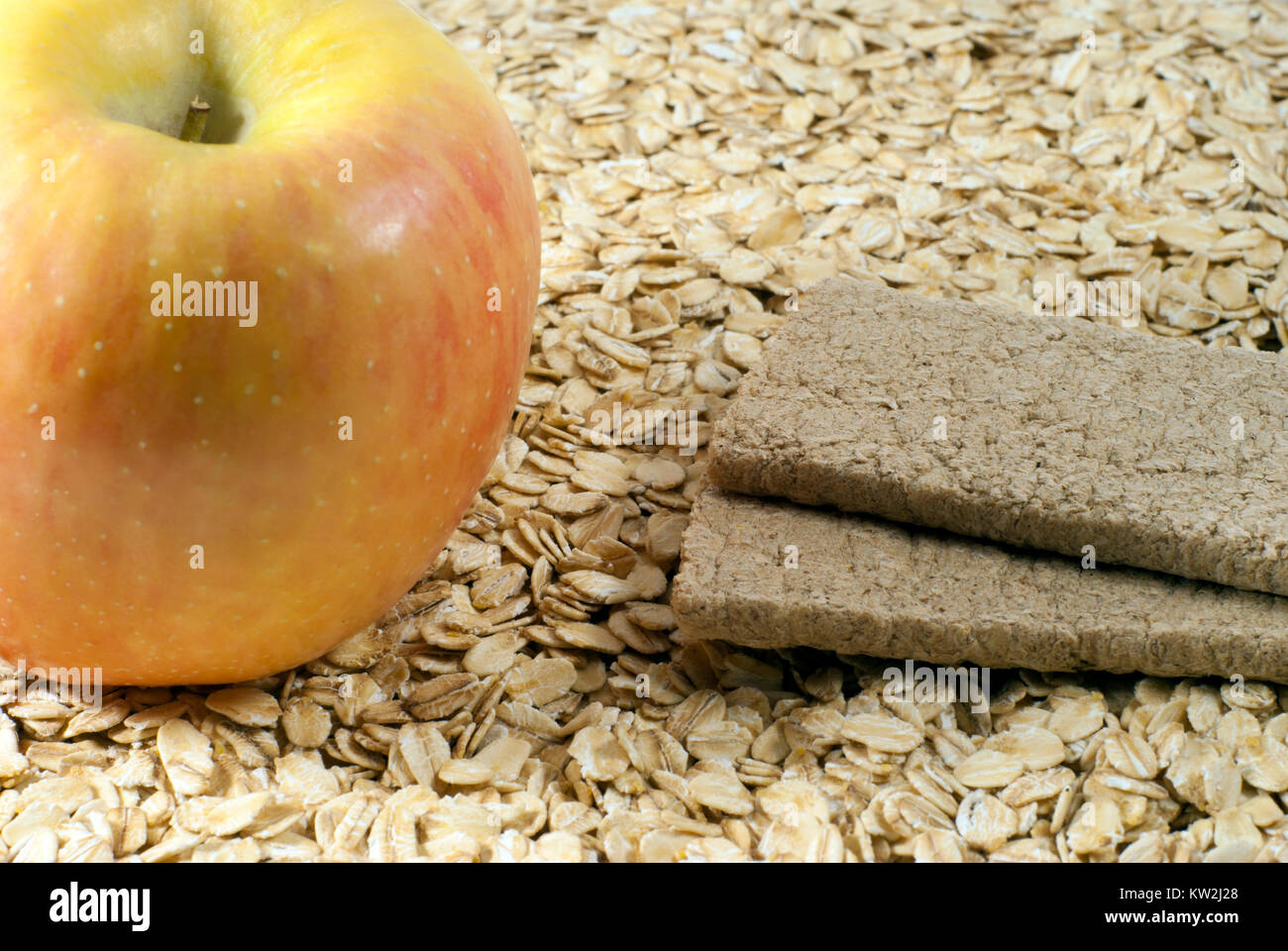 Ingredients for breakfast - porridge with apple: apple, oat flakes and a couple of dietary rye bread Stock Photo
