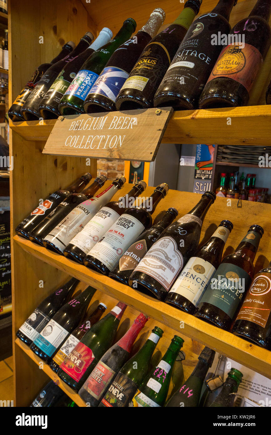 Assortment of beer bottles of Belgian and international beers on display in pub in Flanders, Belgium Stock Photo