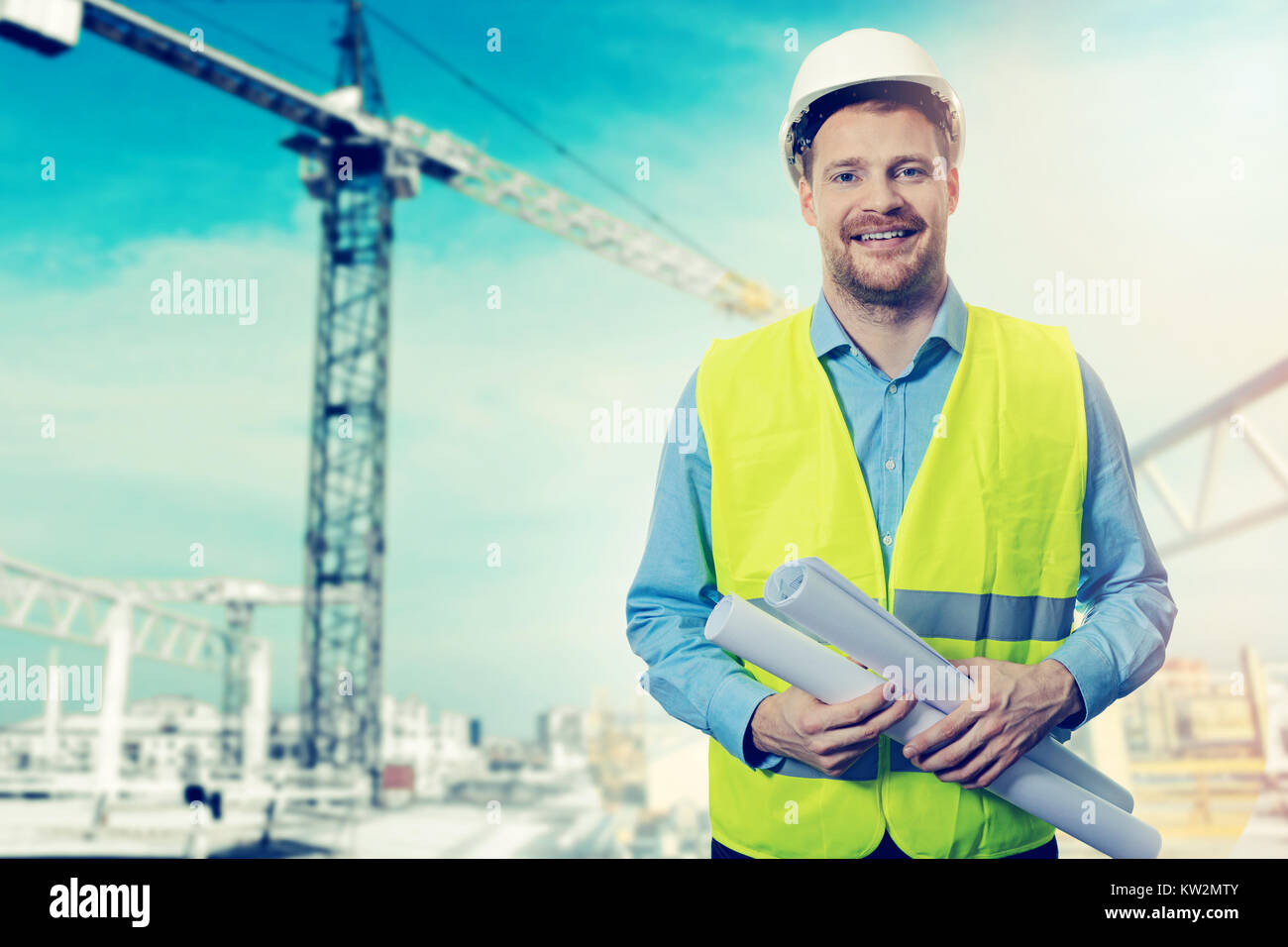construction project engineer with blueprints at building site Stock Photo