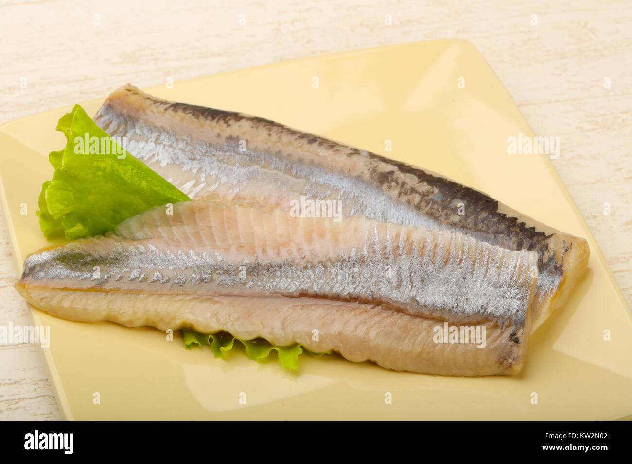 Herring fillet over salad leaves ready for eat Stock Photo Alamy