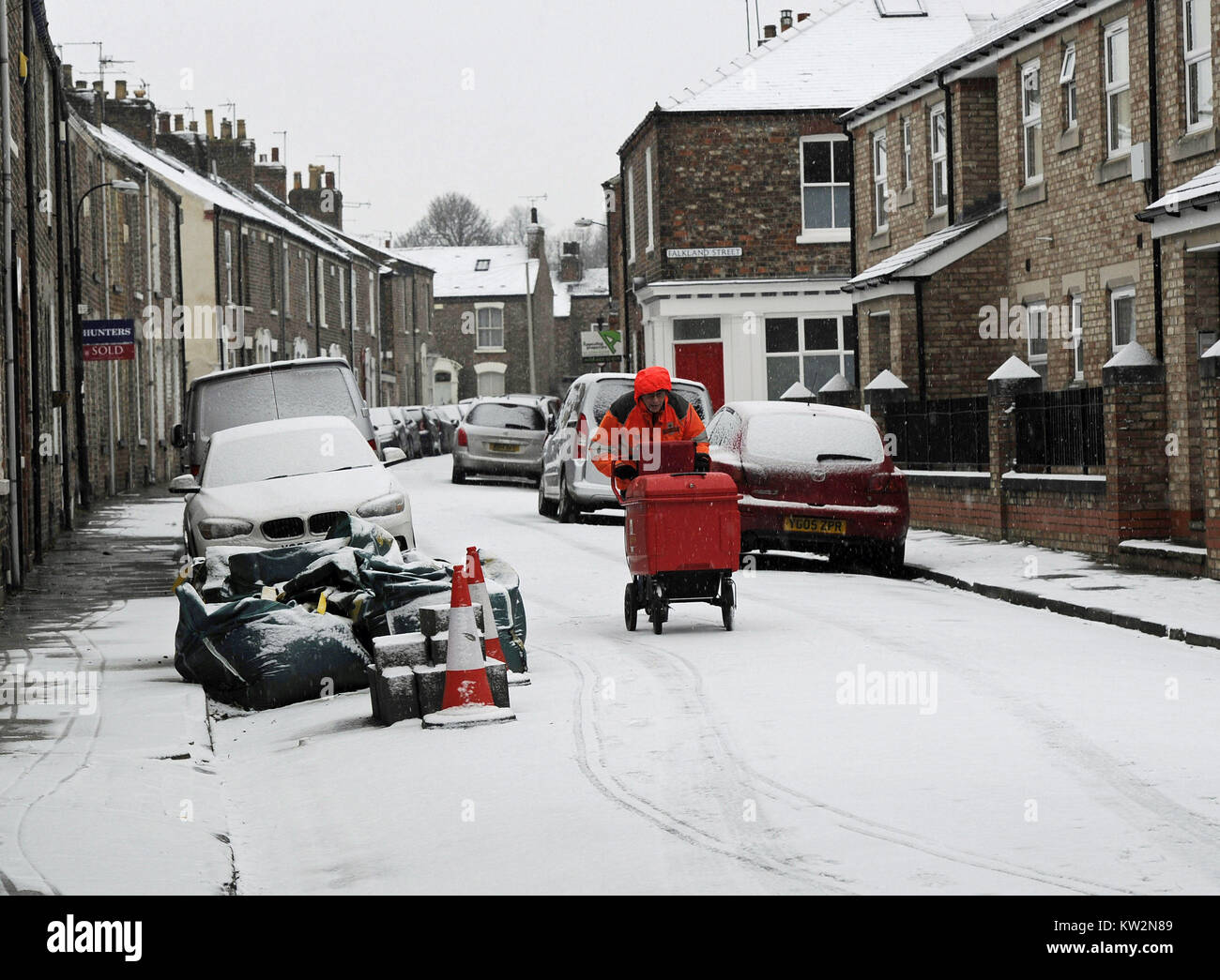 A postman makes deliveries through the snow in York after Britain saw one of the coldest nights of the year with temperatures falling to minus 12.3C at Loch Glascarnoch in the Scottish Highlands overnight and heavy snow expected over part of the north of England. Stock Photo