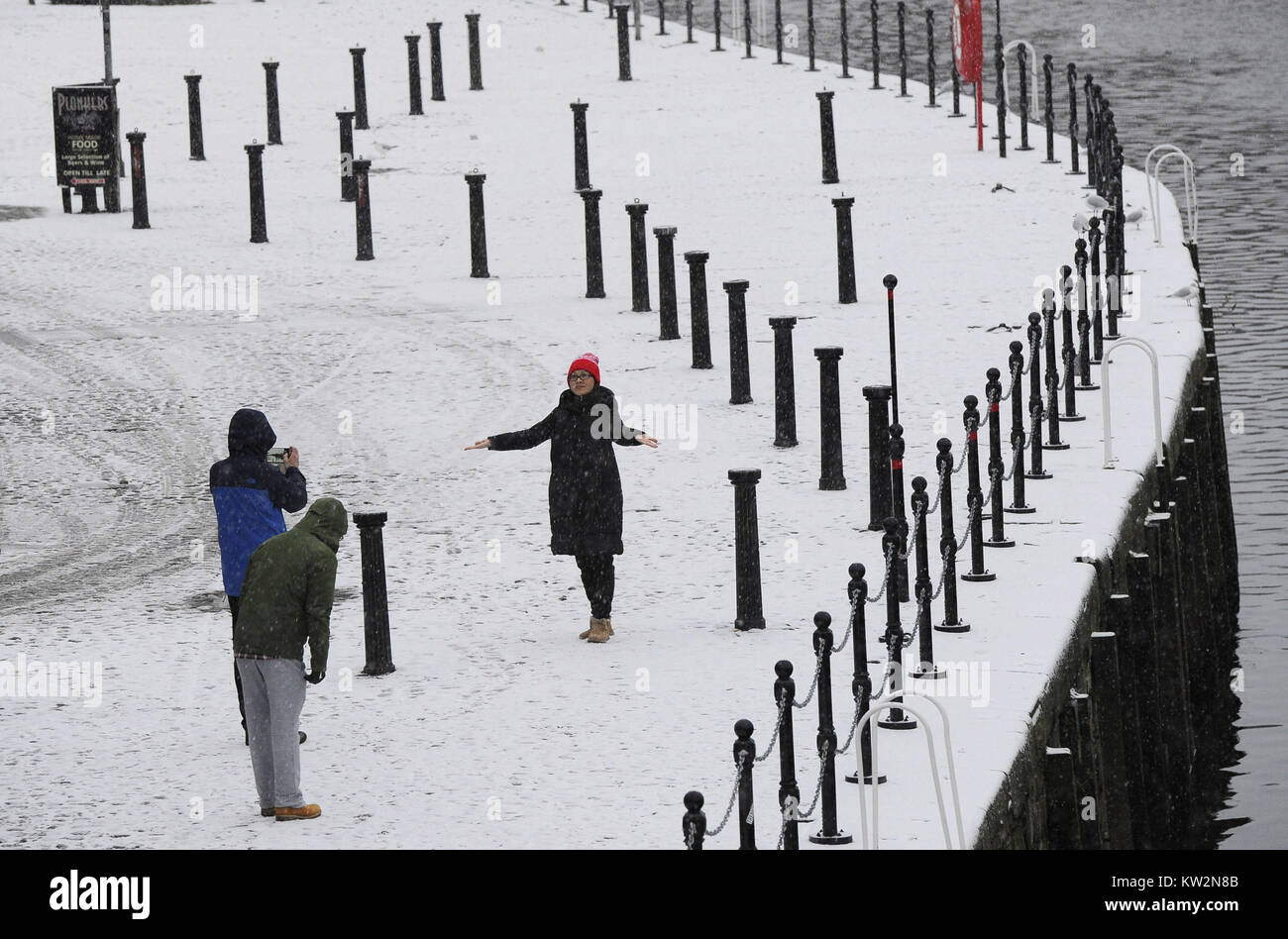 People take photos in the snow in York after Britain saw one of the coldest nights of the year with temperatures falling to minus 12.3C at Loch Glascarnoch in the Scottish Highlands overnight and heavy snow expected over part of the north of England. Stock Photo
