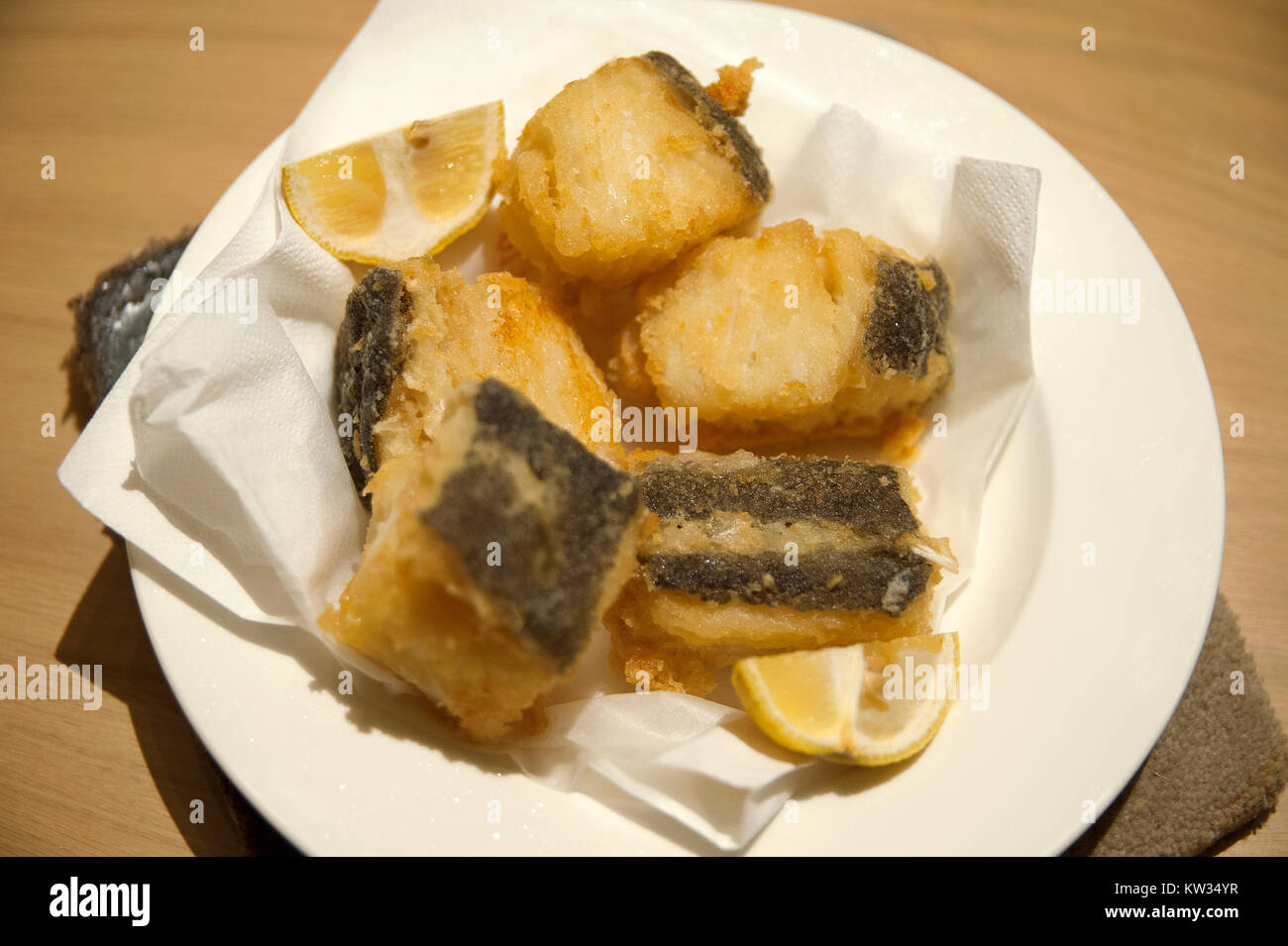 Fried salted cod fish with lemon Stock Photo Alamy