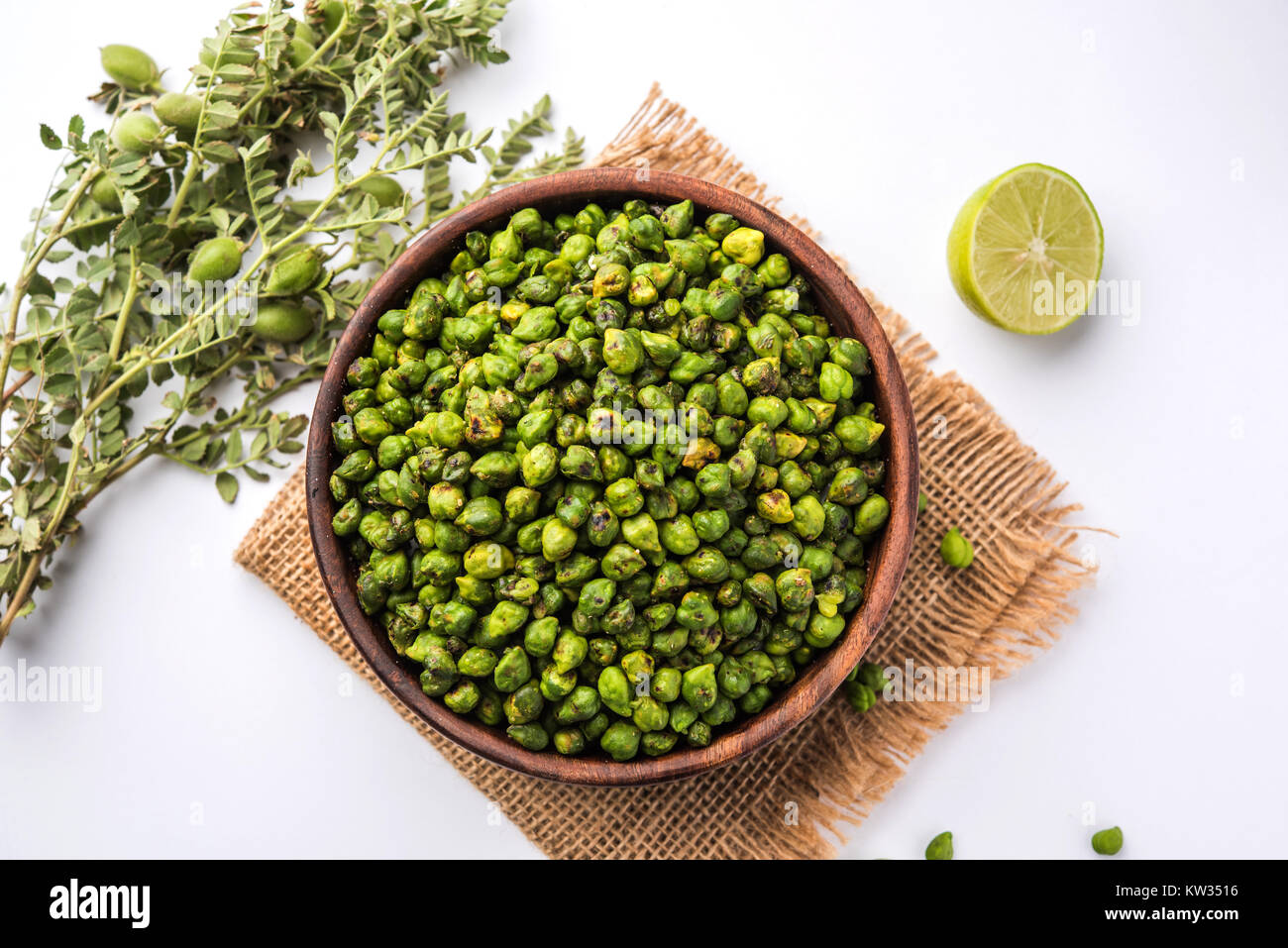 Roasted fresh Green Chickpeas or Chick Peas or harbara in hindi also known as Cicer with pinch of salt and chat masala and lemon, popular snack from I Stock Photo
