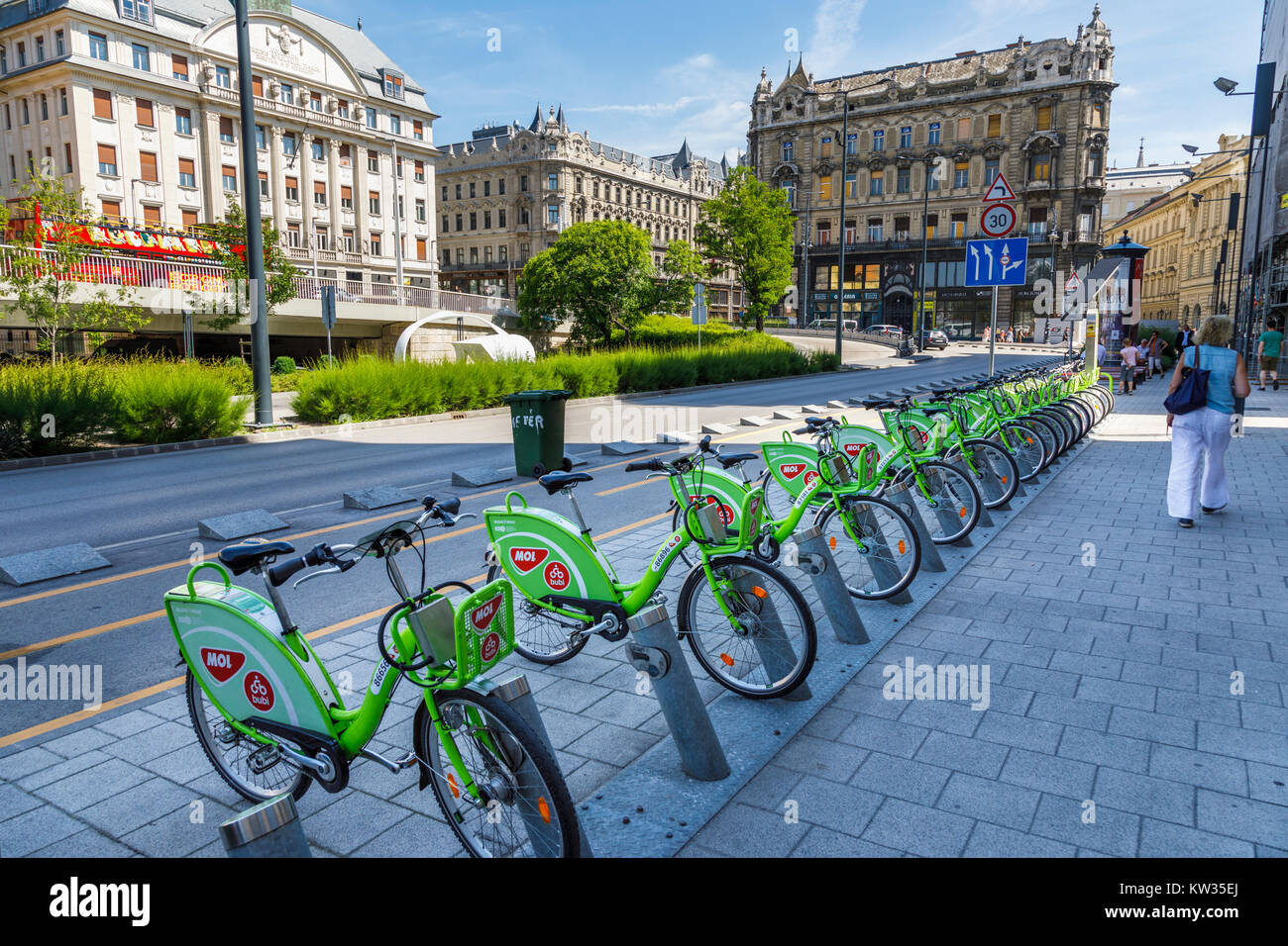 Row of green rental bikes for hire lined up in pay racks against historic  buildings in Pest, Budapest, capital city of Hungary, central Europe Stock  Photo - Alamy