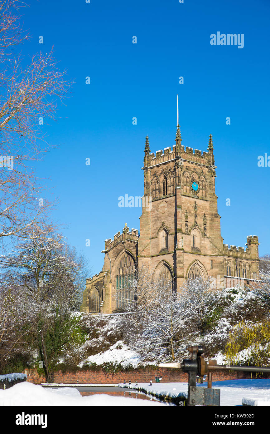 St. Mary's Church, Kidderminster, UK, on a bright sunny morning with snow on the ground & bright, blue sky. Picturesque winter scene. Portrait format. Stock Photo