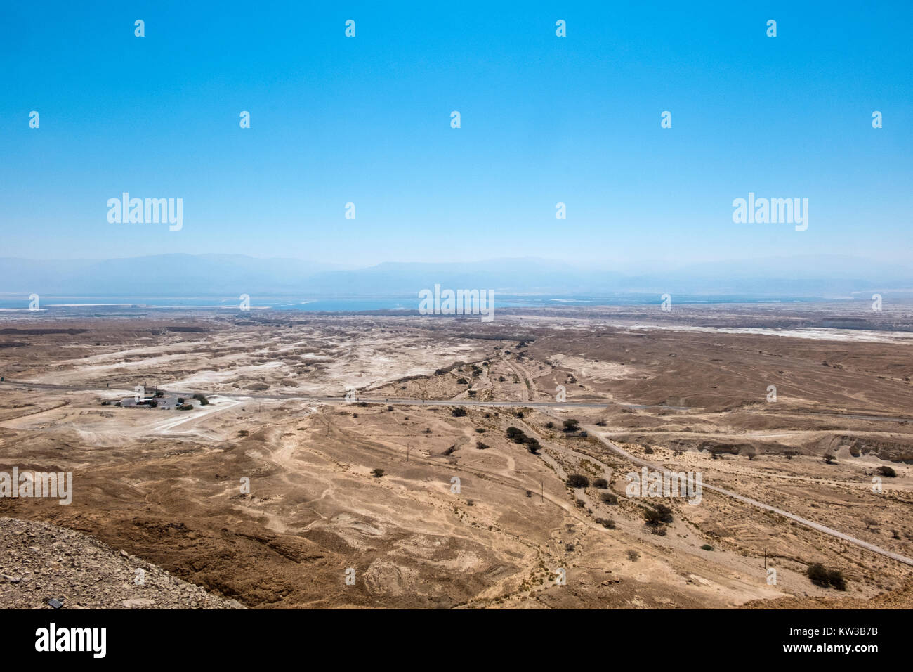 The Arava valley and the shore of the Dead Sea in the background in the haze can be seen the ridges of the Edom Mountains Stock Photo