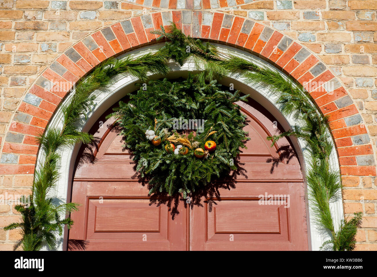 USA Virginia VA Colonial Williamsburg Christmas Holiday wreaths hanging on doors and windows on the Duke of Gloucester Street Stock Photo