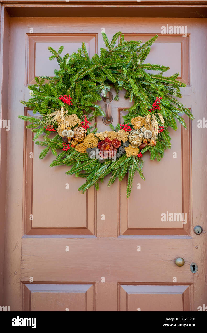 USA Virginia VA Colonial Williamsburg Christmas Holiday wreaths hanging on doors and windows on the Duke of Gloucester Street Stock Photo