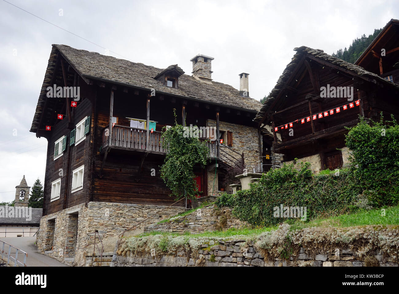 CRESCIANO, SWITZERLAND - CIRCA AUGUDST 2015 Traditional Swiss wooden houses on the street Stock Photo