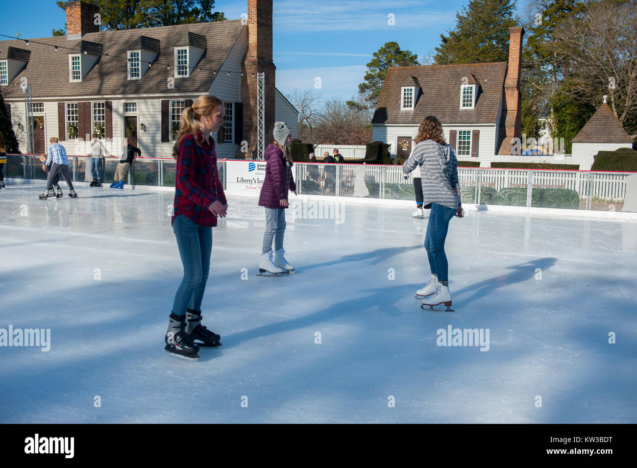 USA Virginia VA Colonial Williamsburg Winter Christmas Ice Skating on a small rink on the Duke of Gloucester Street during the holiday season Stock Photo