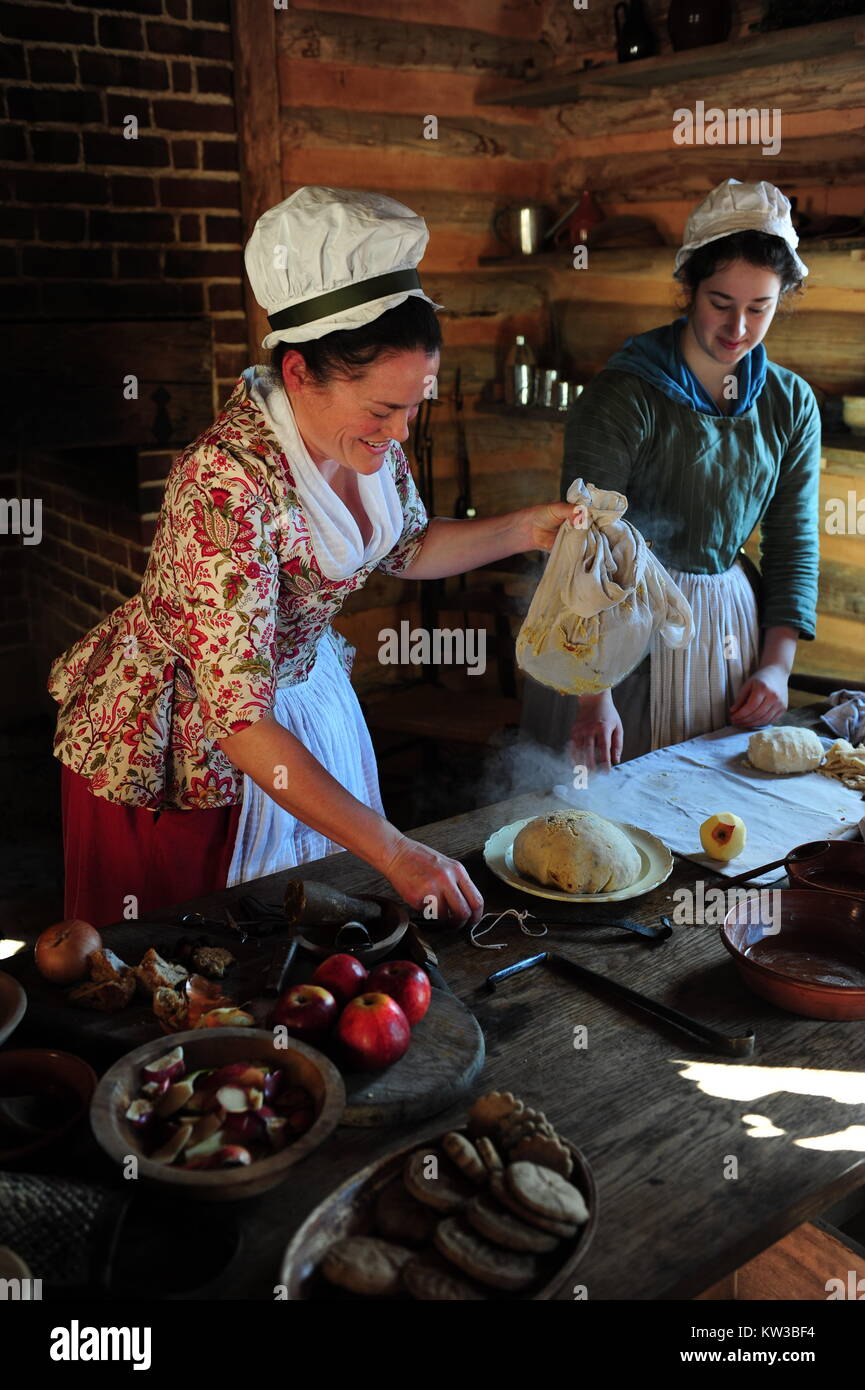 USA Virginia VA Colonial Yorktown two historical interpreters preparing a Figgy Pudding for winter holiday meal Stock Photo