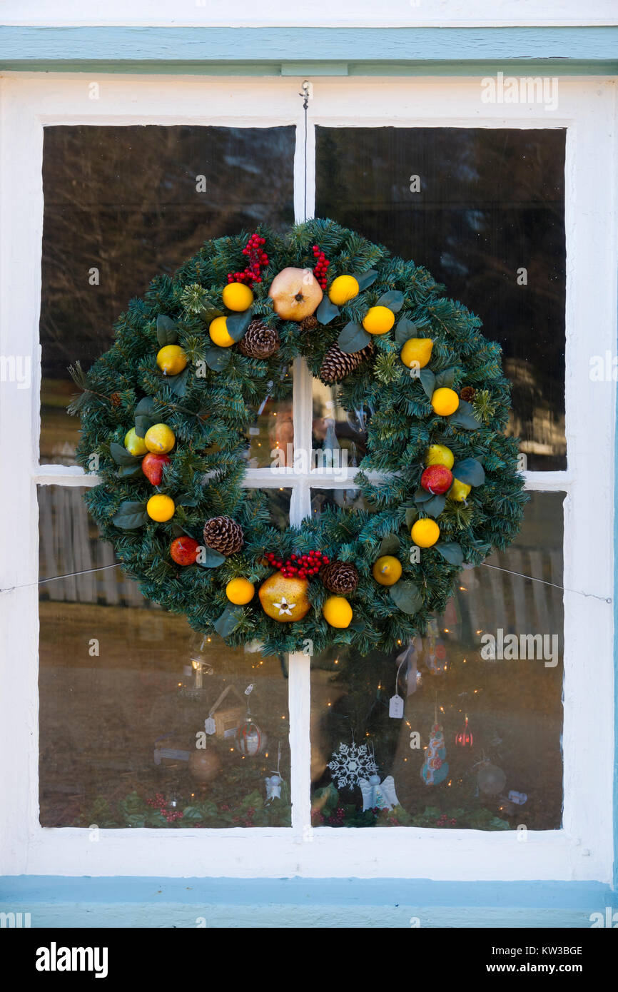 USA Virginia VA Colonial Yorktown Christmas decorations adorn the town wreath on a door window Stock Photo