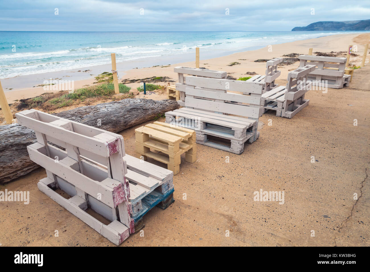 Standard white furniture made of wooden cargo pallets, cheap seaside terrace. Porto Santo island, Madeira archipelago, Portugal Stock Photo