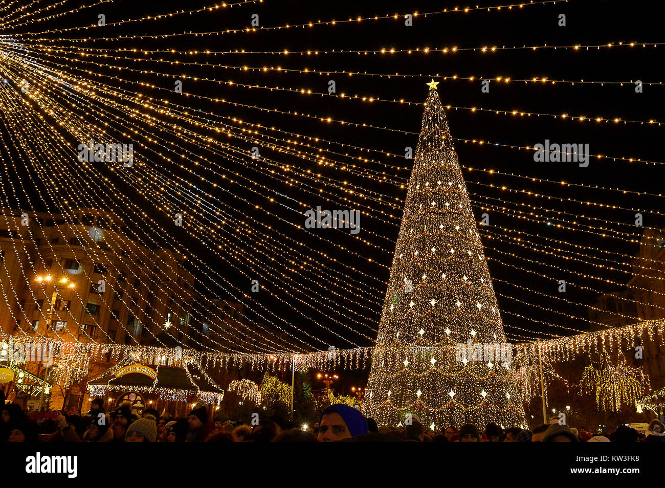 BUCHAREST, ROMANIA - 6 DECEMBER 2017: Crowds with Christmas tree and lights at the Christmas Fair/Christmas Market in Piata Constitutiei (Constitution Stock Photo