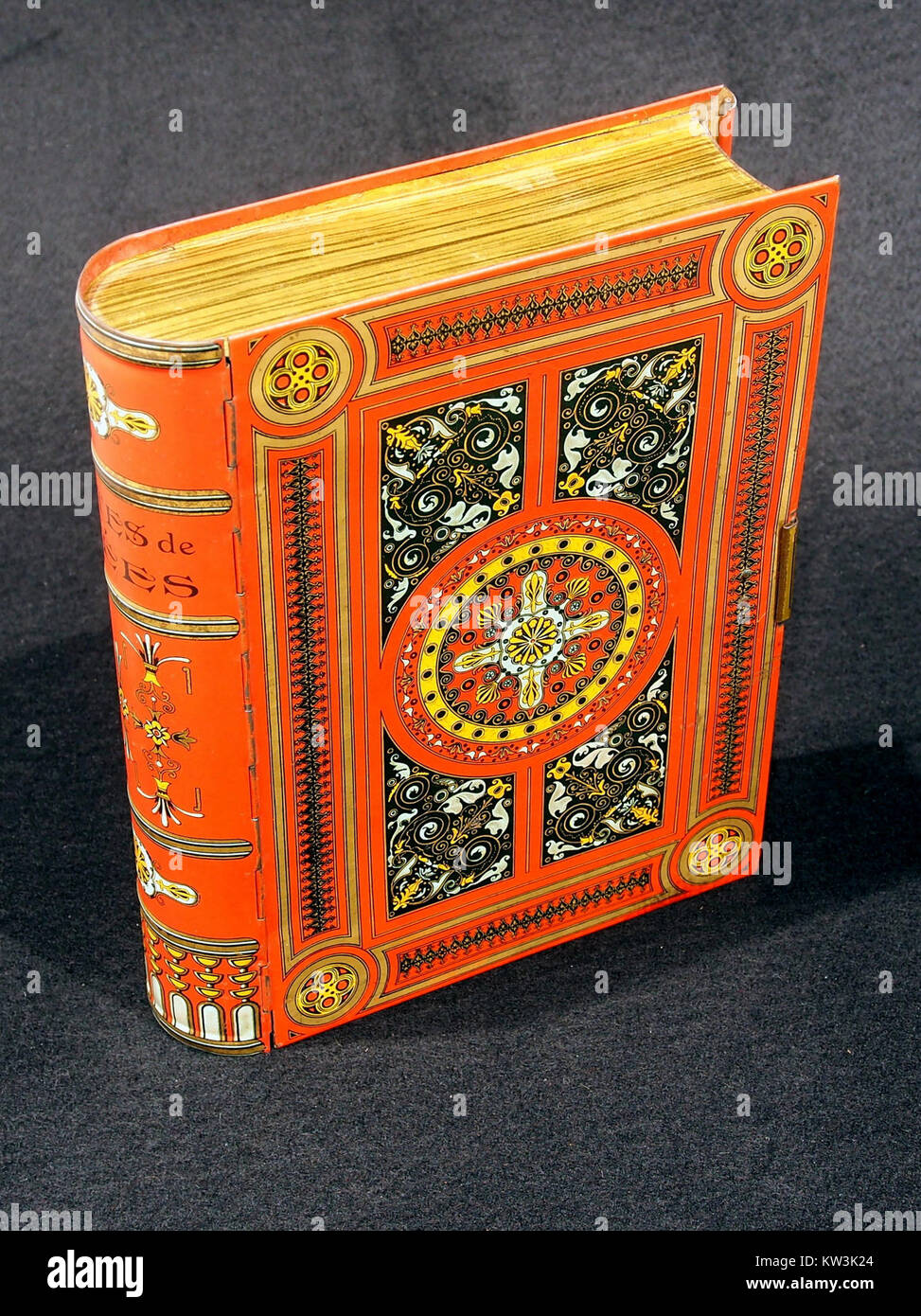 A biscuit tin shaped like a book, produced around 1920. This item reflects the early 20th-century design trends, combining functional storage with decorative form. Stock Photo