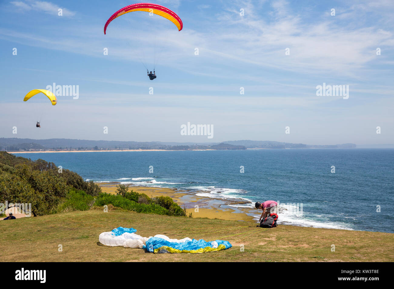 Hang gliding and paragliding is popular at Long Reef aquatic reserve on Sydney northern beaches,Australia Stock Photo