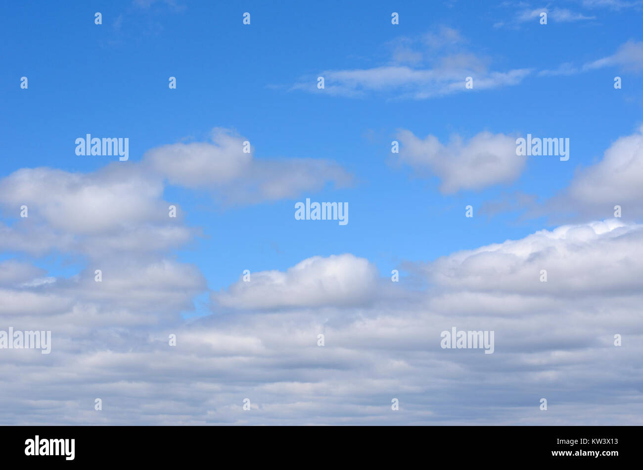 This image captures a serene sky filled with blue and white clouds ...