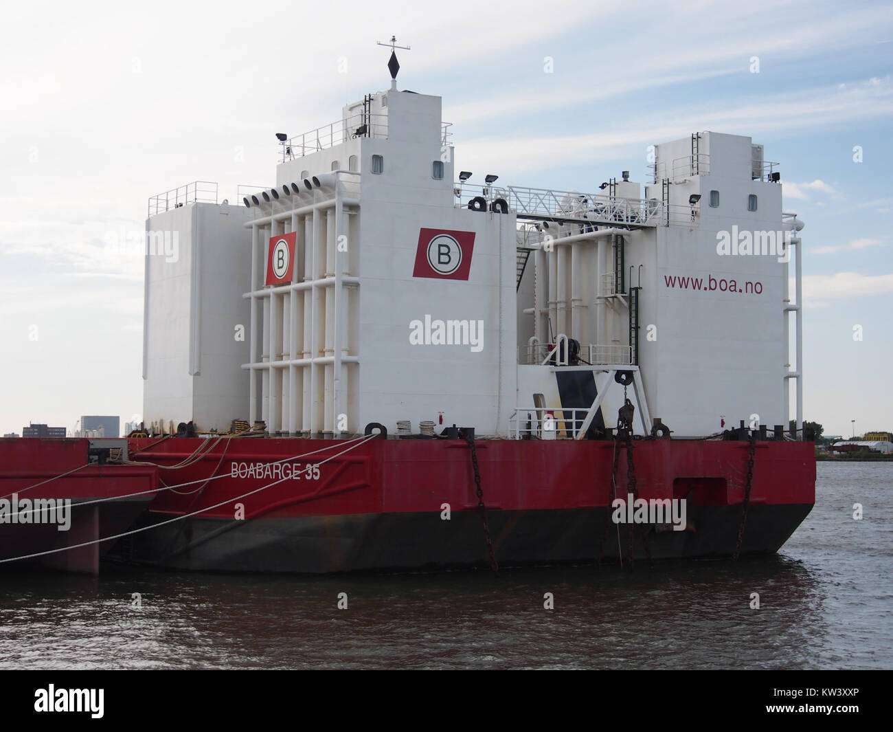 The Boabarge 35 is a large barge located on the Nieuwe Maas River in the Netherlands. It is commonly used for transportation and shipping. The Nieuwe Maas River, a major distributary of the Rhine, is an important waterway that connects Rotterdam to the North Sea. The Boabarge 35 is one of the many barges that navigate this key water route, contributing to trade and commerce in the region. Stock Photo