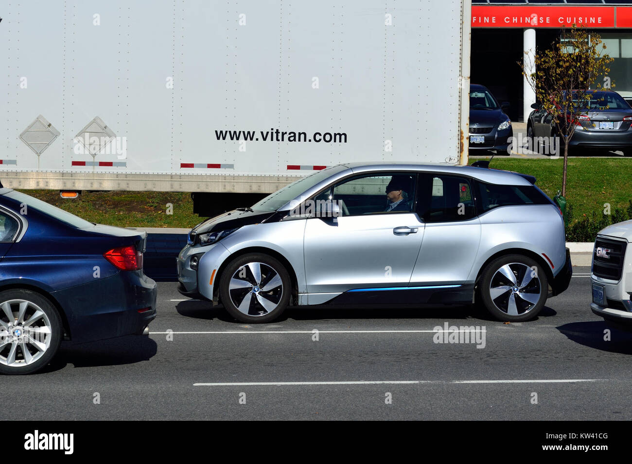 This image shows a BMW i3 electric car on Highway 71, a modern example of sustainable transportation, highlighting the growing trend of electric vehicles in urban and rural areas. Stock Photo