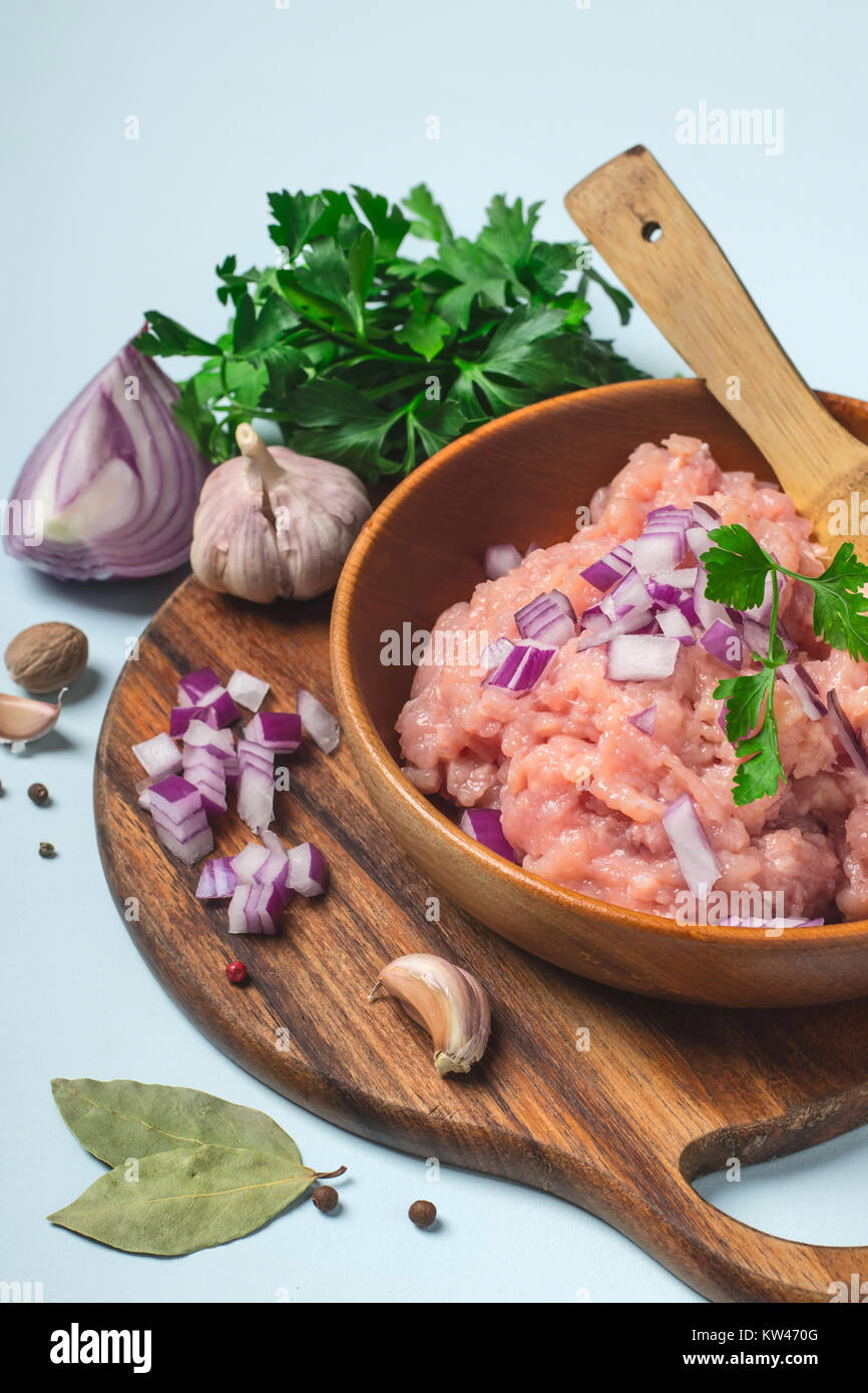 Raw chicken meat mince in a bowl with spices Stock Photo - Alamy