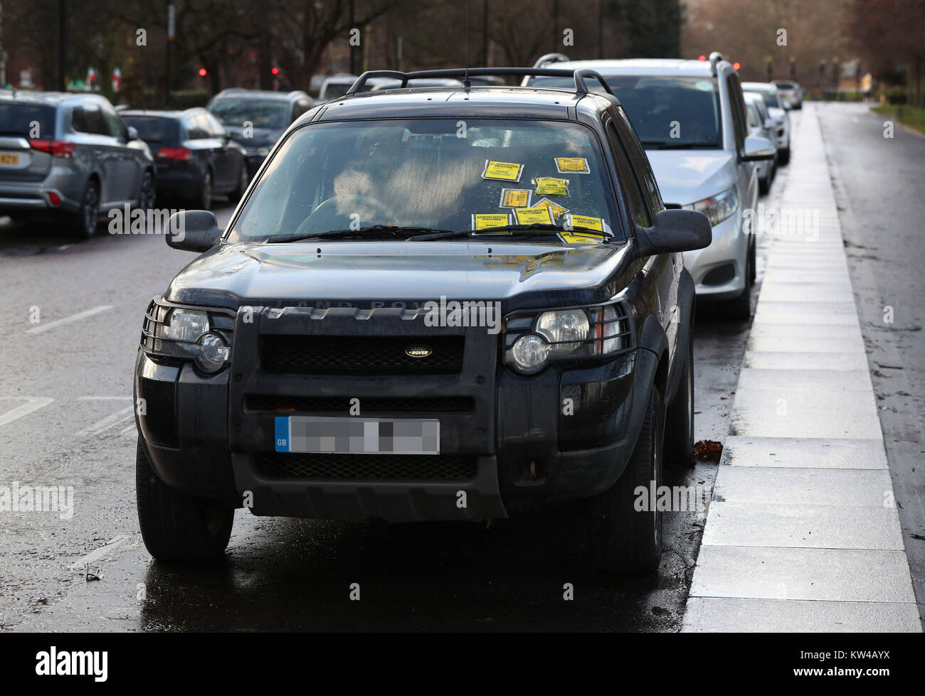 NUMBER PLATE PIXELATED BY THE PA PICTURE DESK Parking Notice fixed penalties are attached to the windscreen of a Land Rover Freelander on South Carriage Drive in Hyde Park, London. Stock Photo