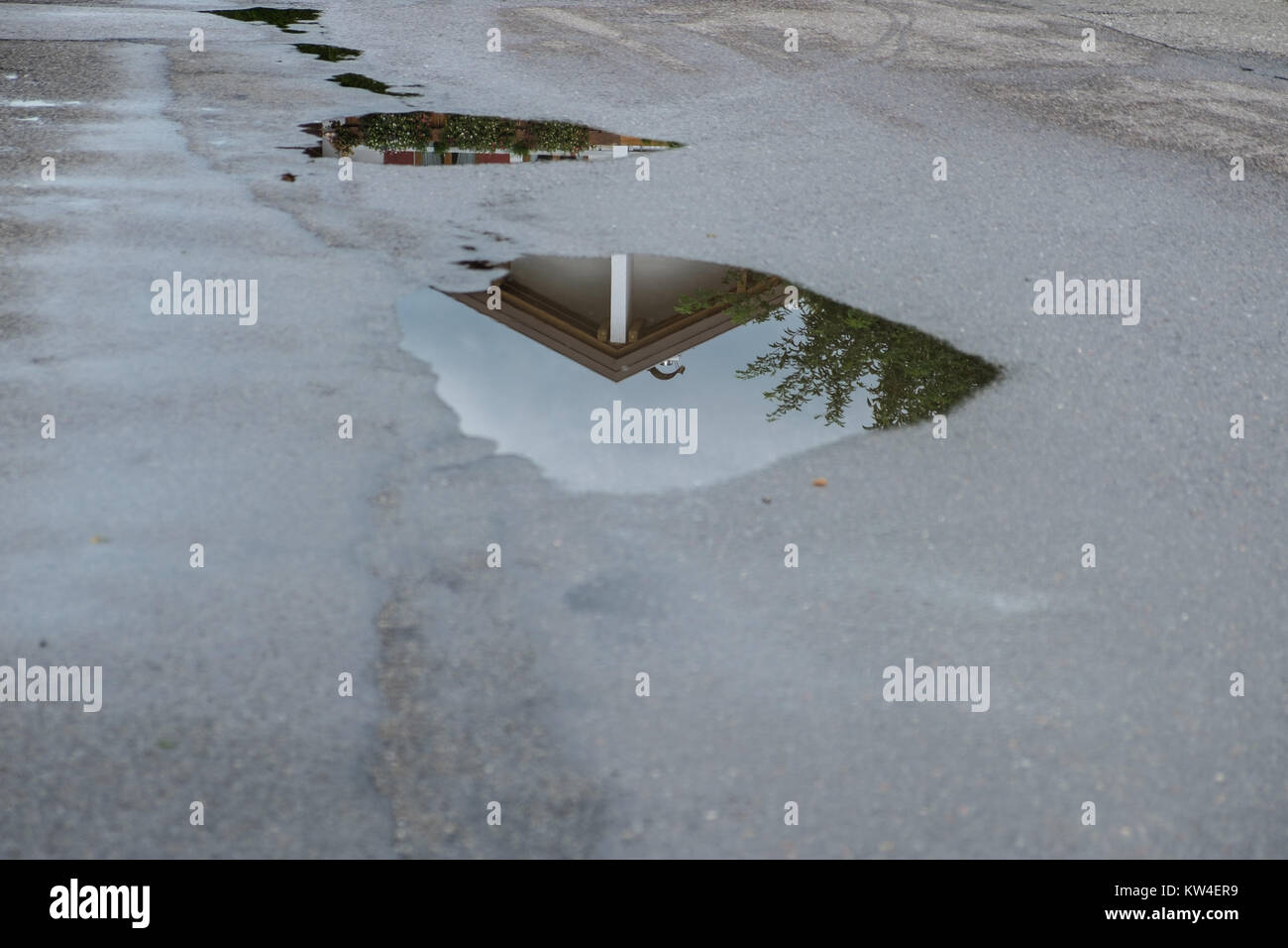 Reflection of a house in a water puddle after a thunderstorm Stock ...