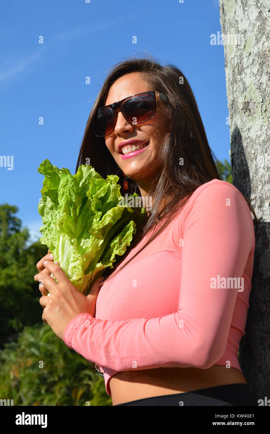 Young woman and vegetable, vegan lettuce Stock Photo