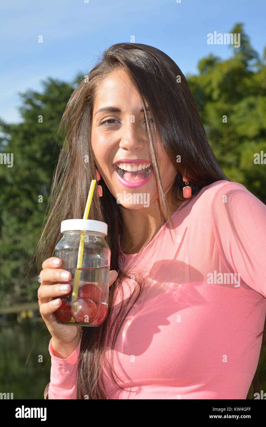 Young Woman smiling with glass jar Stock Photo