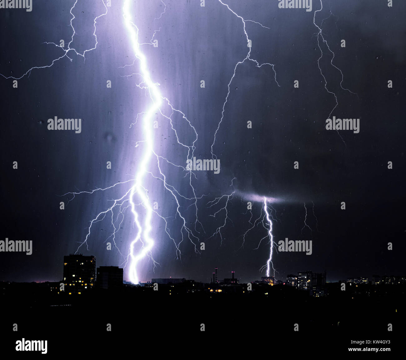 Lightning storm over city, thunderbolt Stock Photo - Alamy