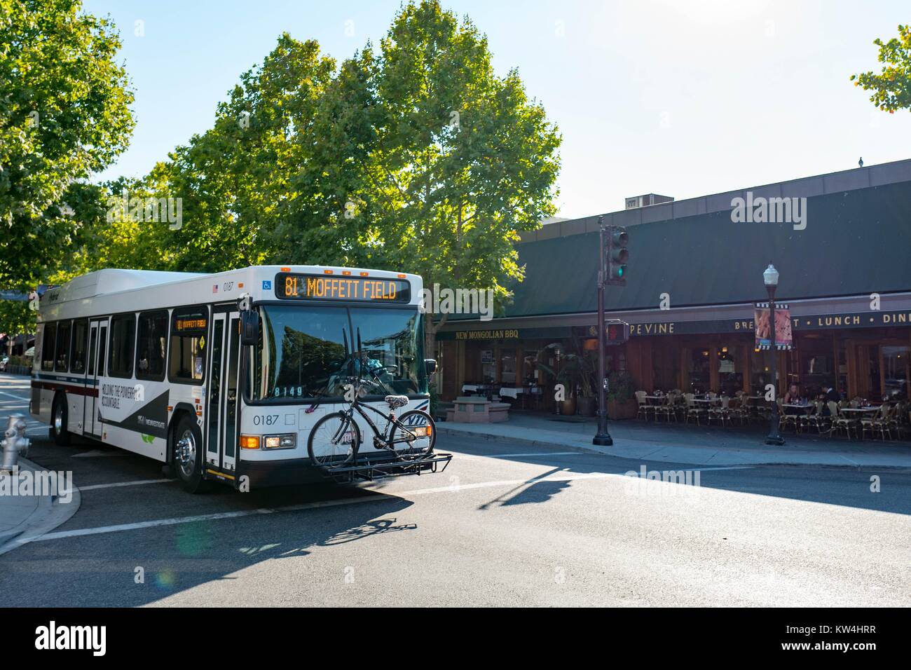 On Castro Street, in the downtown portion of the Silicon Valley town of Mountain View, California, a bus passes by with a sign indicating that it is traveling to Moffett Field, a civil and military airfield, Mountain View, California, August 24, 2016. Stock Photo