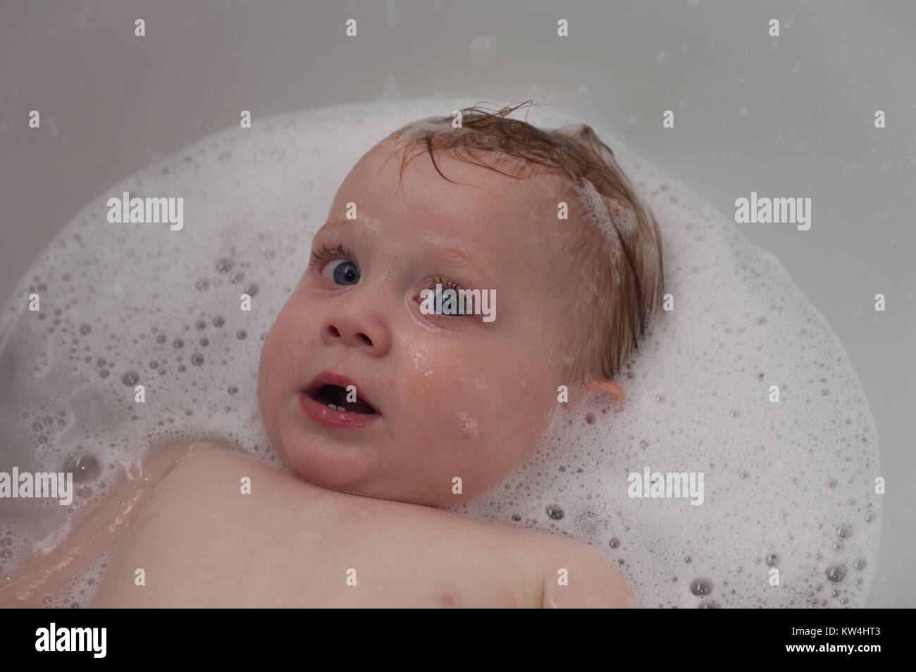 baby boy bathing in foam Stock Photo Alamy