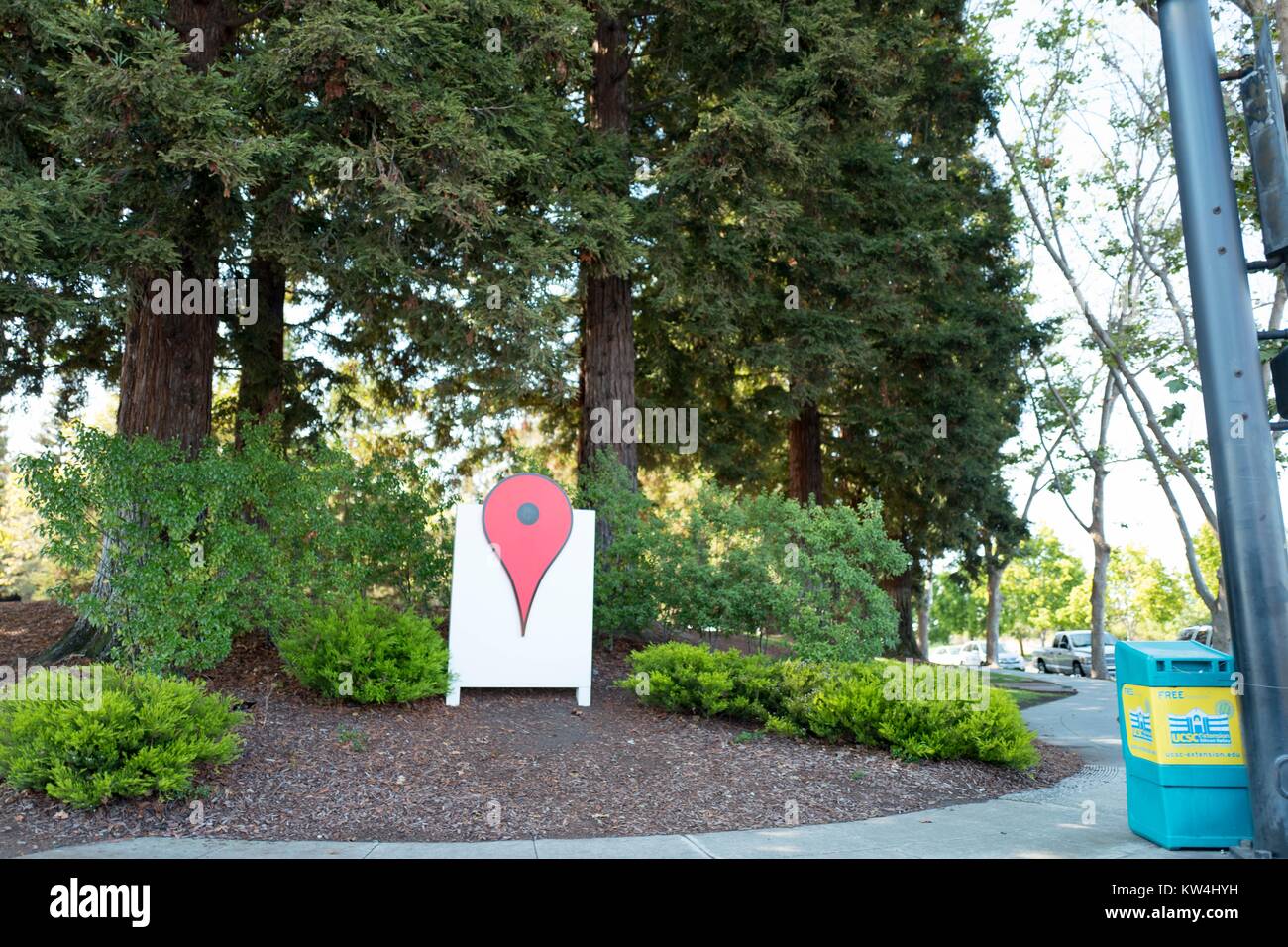 Life-sized representation of the iconic red pin from the Google Maps mapping application installed in a wooded area at the Googleplex, headquarters of the search engine company Google in the Silicon Valley town of Mountain View, California, August 24, 2016. Stock Photo