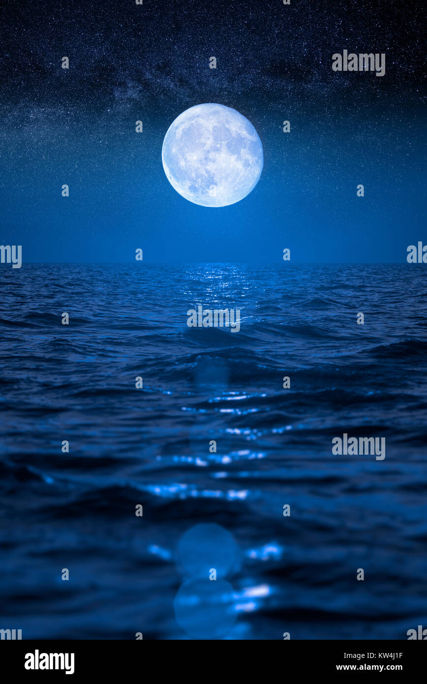 Full Moon Rising Over Empty Ocean At Night Stock Photo Alamy