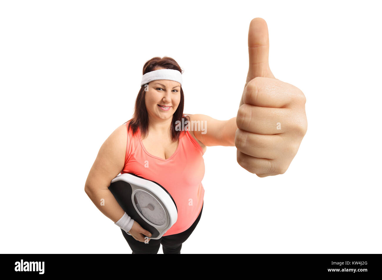 Overweight woman with a weight scale making a thumb up gesture isolated on white background Stock Photo