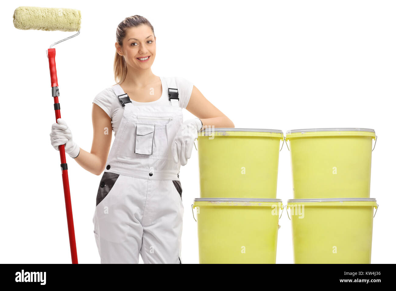 Female painter holding a paint roller and leaning on color buckets ...