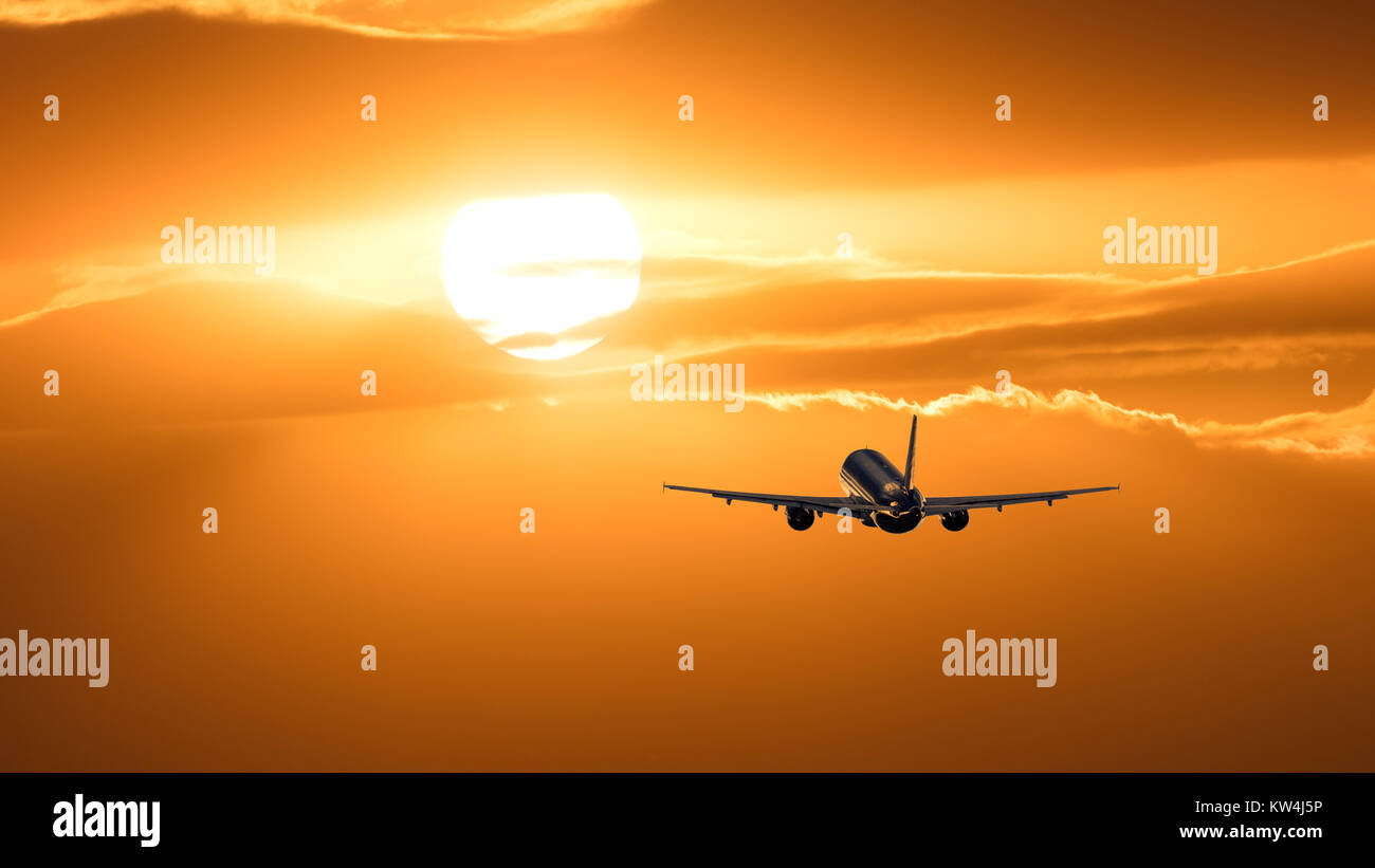 Plane is taking off at sunset Stock Photo - Alamy