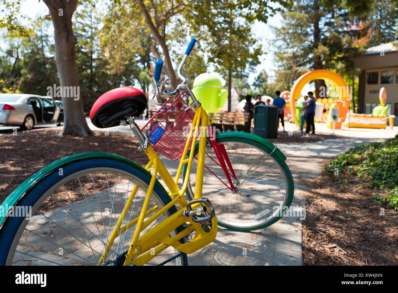 Colorful Google Bike parked in front of the Android Sculpture Park at the Googleplex, headquarters of the search engine company Google in the Silicon Valley town of Mountain View, California, August 24, 2016. Employees are encouraged to ride the free bikes around Google's campus, and to leave them in front of Google buildings once they arrive at their destination, Mountain View, California. Stock Photo