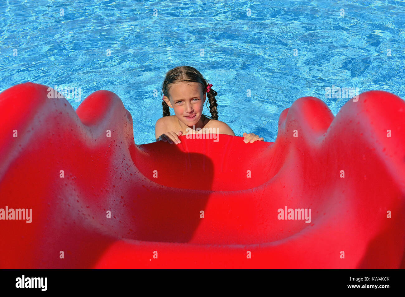 Little girl in swimmingpool with slides.. Swimming pool slides for