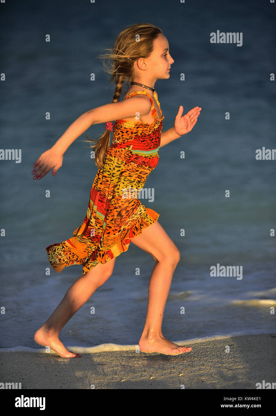 Cute little girl running on beach in sunset light. Cuba Stock Photo Alamy