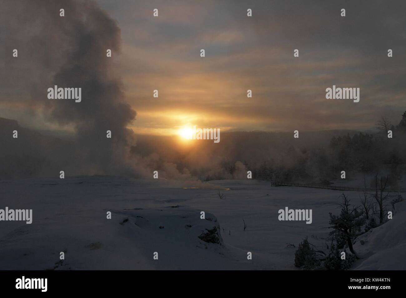 Yellowstone Rising Sun Steam rising over Mammoth Hot Springs at sunrise, Yellowstone National ...