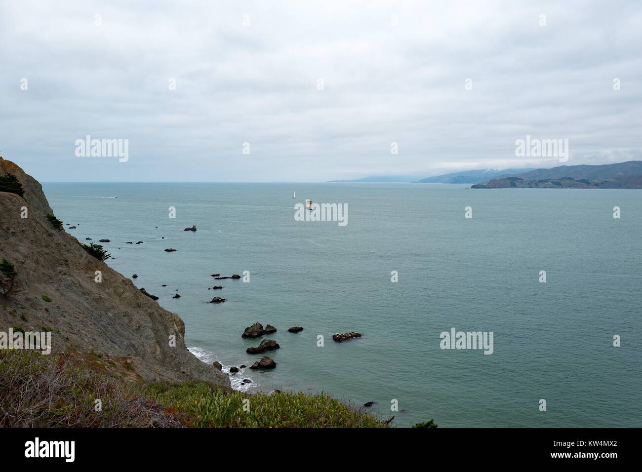 Gulf of the Farallones with cliffs leading down to the water on a foggy day, viewed from Coastal Trail in the Lands End neighborhood of San Francisco, California, August 27, 2016. Stock Photo