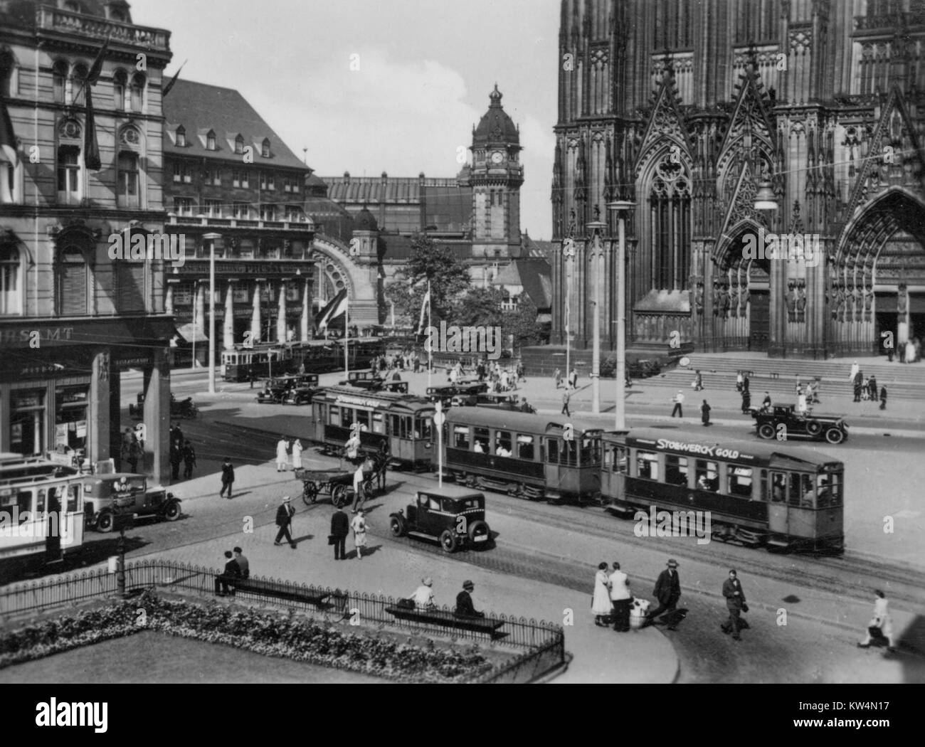 Street scene of train station and public square outside the Cologne Cathedral in Cologne, Germany, 1950. Stock Photo