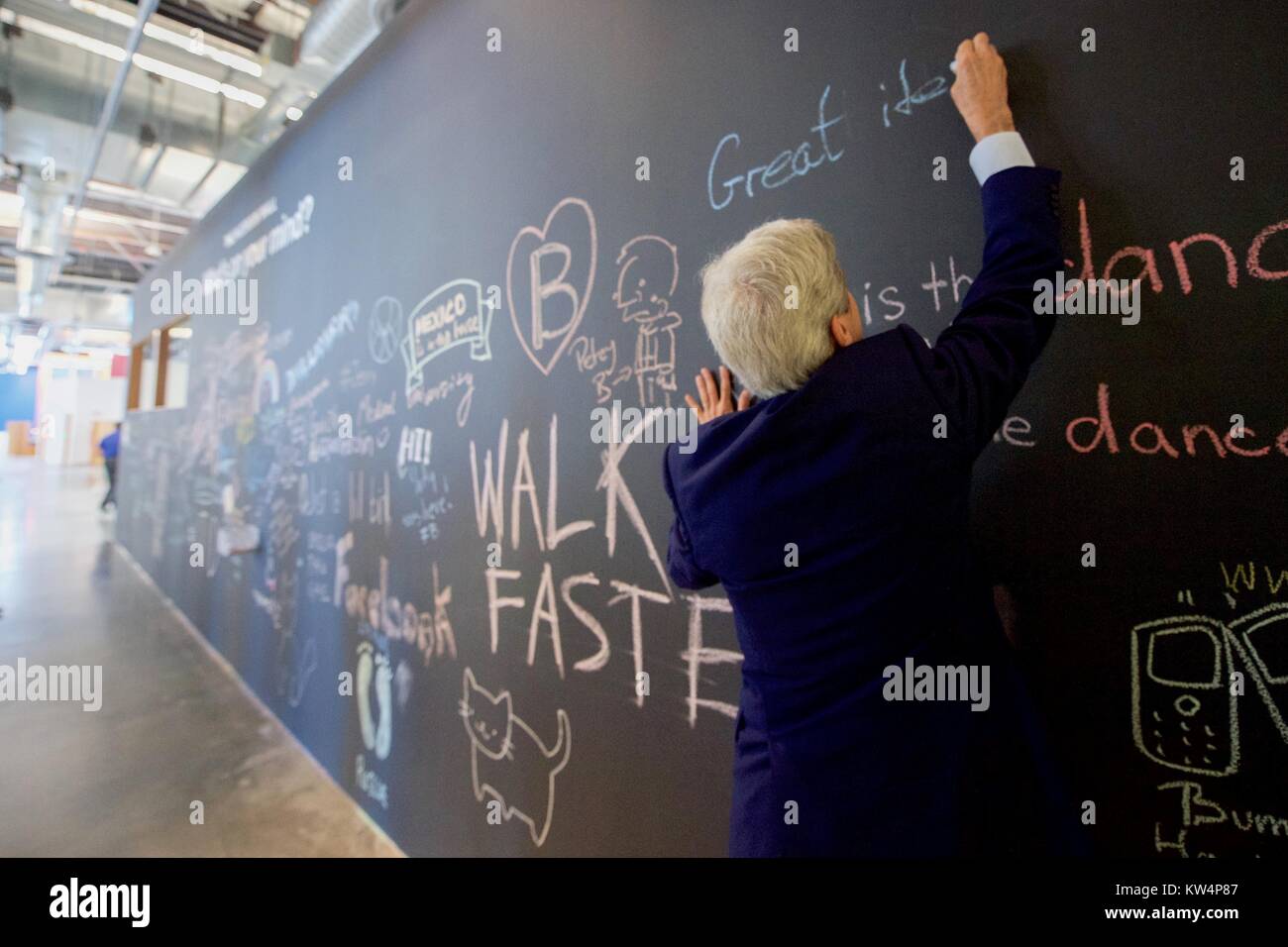 US Secretary of State John Kerry signs a message on the Facebook wall at their new headquarters in Menlo Park, California, before meeting with CEO Mark Zuckerberg, June 23, 2016. Earlier, Secretary Kerry delivered remarks at the Opening Plenary of the 2016 Global Entrepreneurship Summit and toured the Innovation Marketplace on the campus of Stanford University. Image courtesy US Department of State. Stock Photo