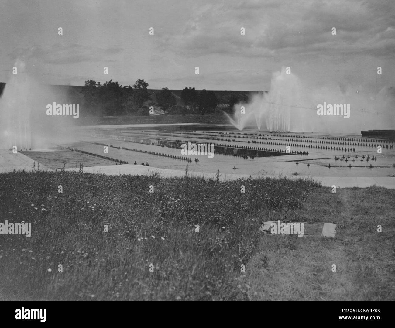 Water is sprayed into the air as the Ashokan reservoir aeration system is in partial operation during construction of the Catskill Aqueduct, New York, United States, June 23, 1916. From the New York Public Library. Stock Photo