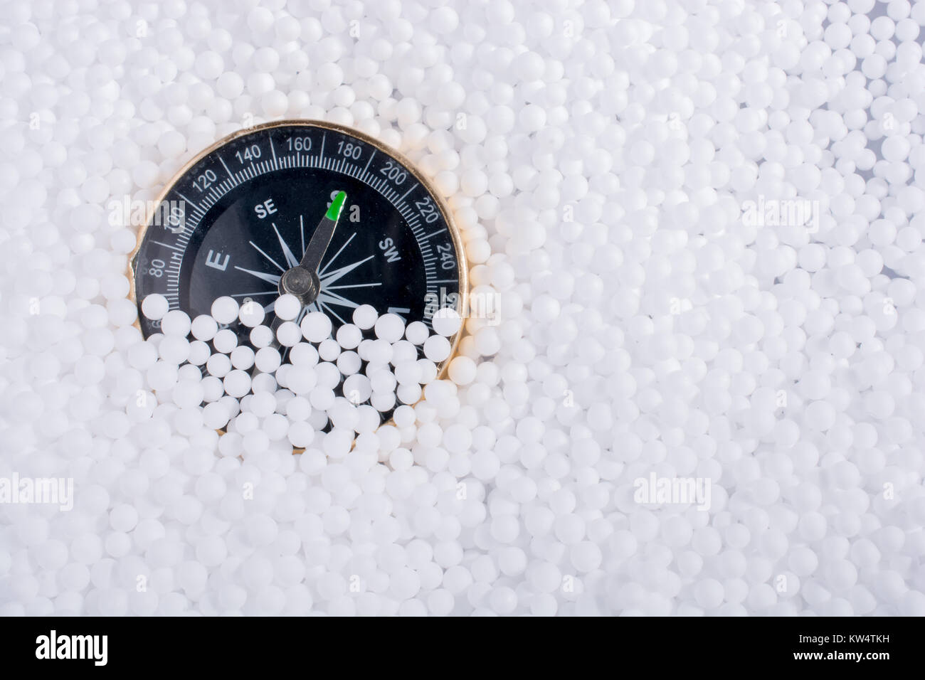 compass on little white polystyrene foam balls Stock Photo - Alamy