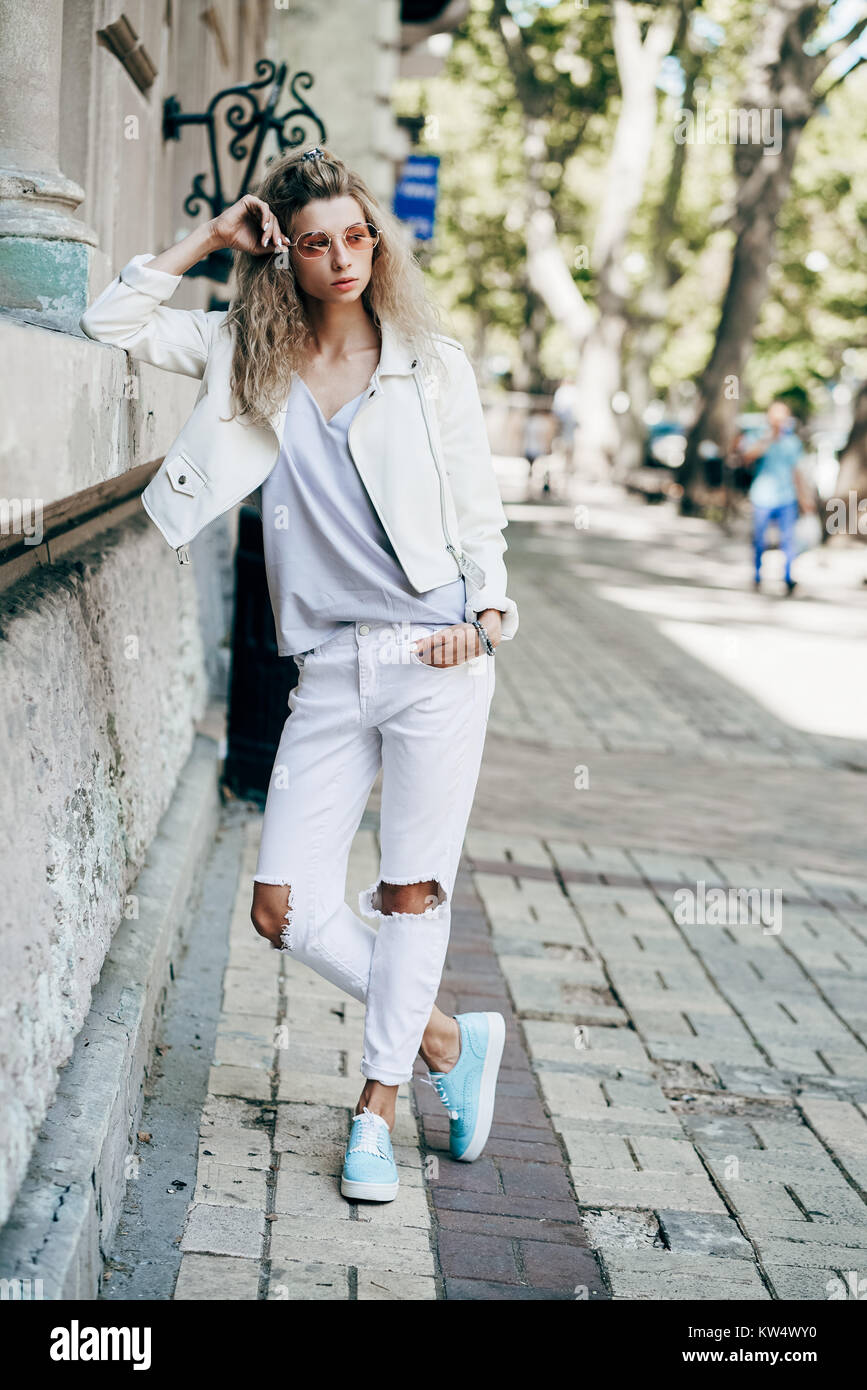 Young woman standing on a city street Stock Photo - Alamy