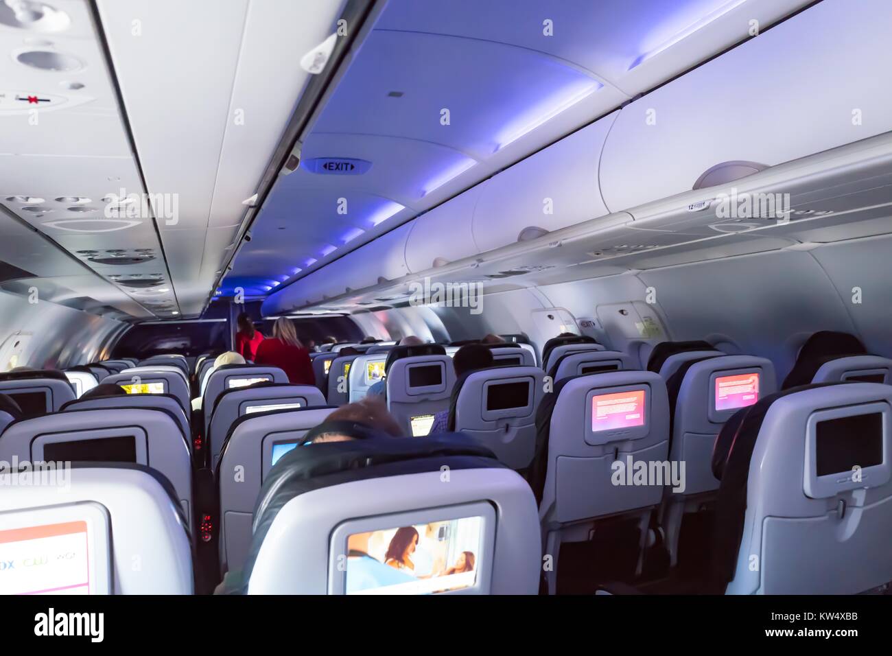 Flight Crew Walk Down The Aisle Of A Virgin America Aircraft Stock