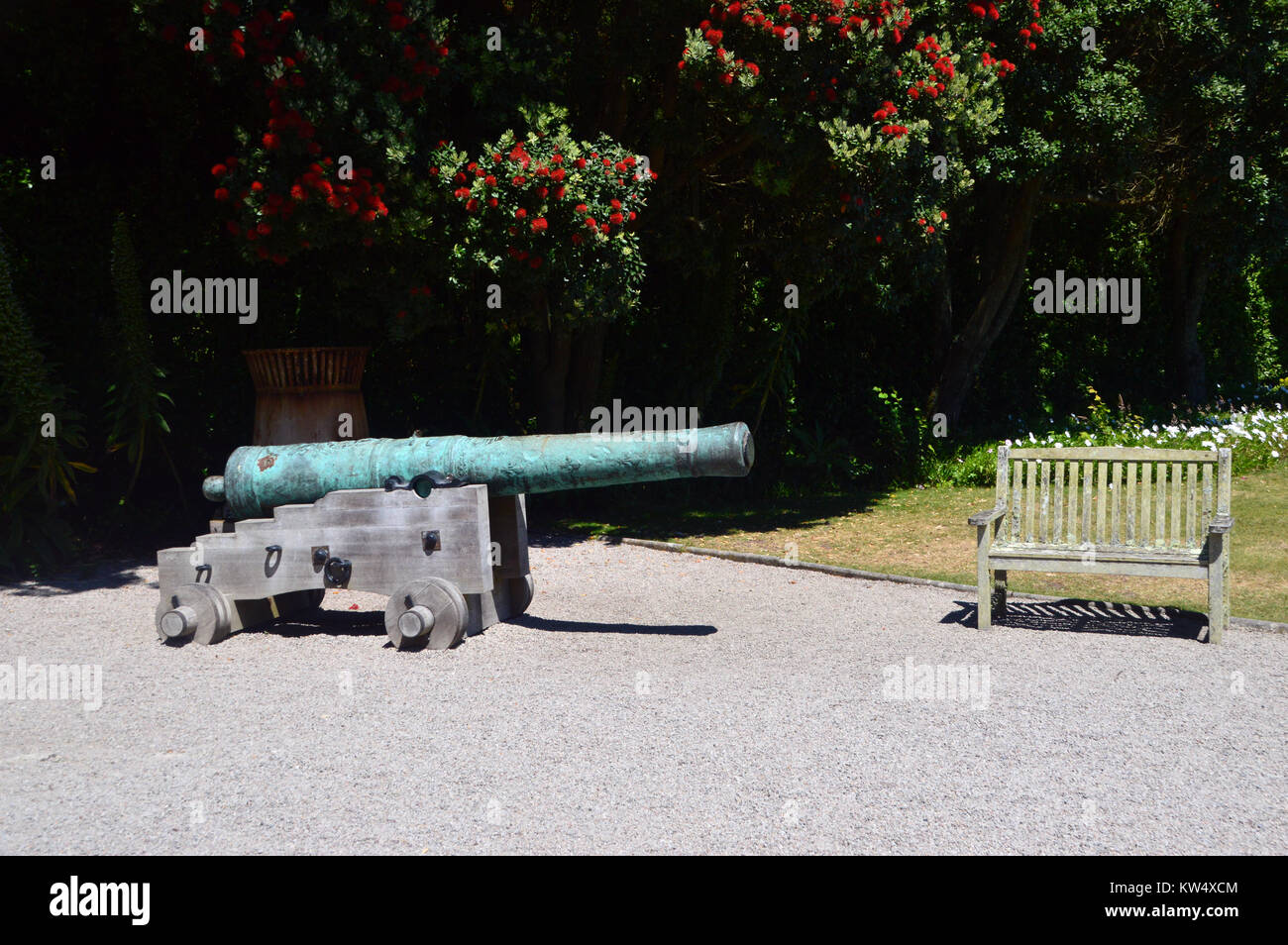 Bronze Cannon and Wooden Bench at the Valhalla Museum in Abbey Gardens on the Island of Tresco on the Isles of Scilly, England, Cornwall, UK. Stock Photo